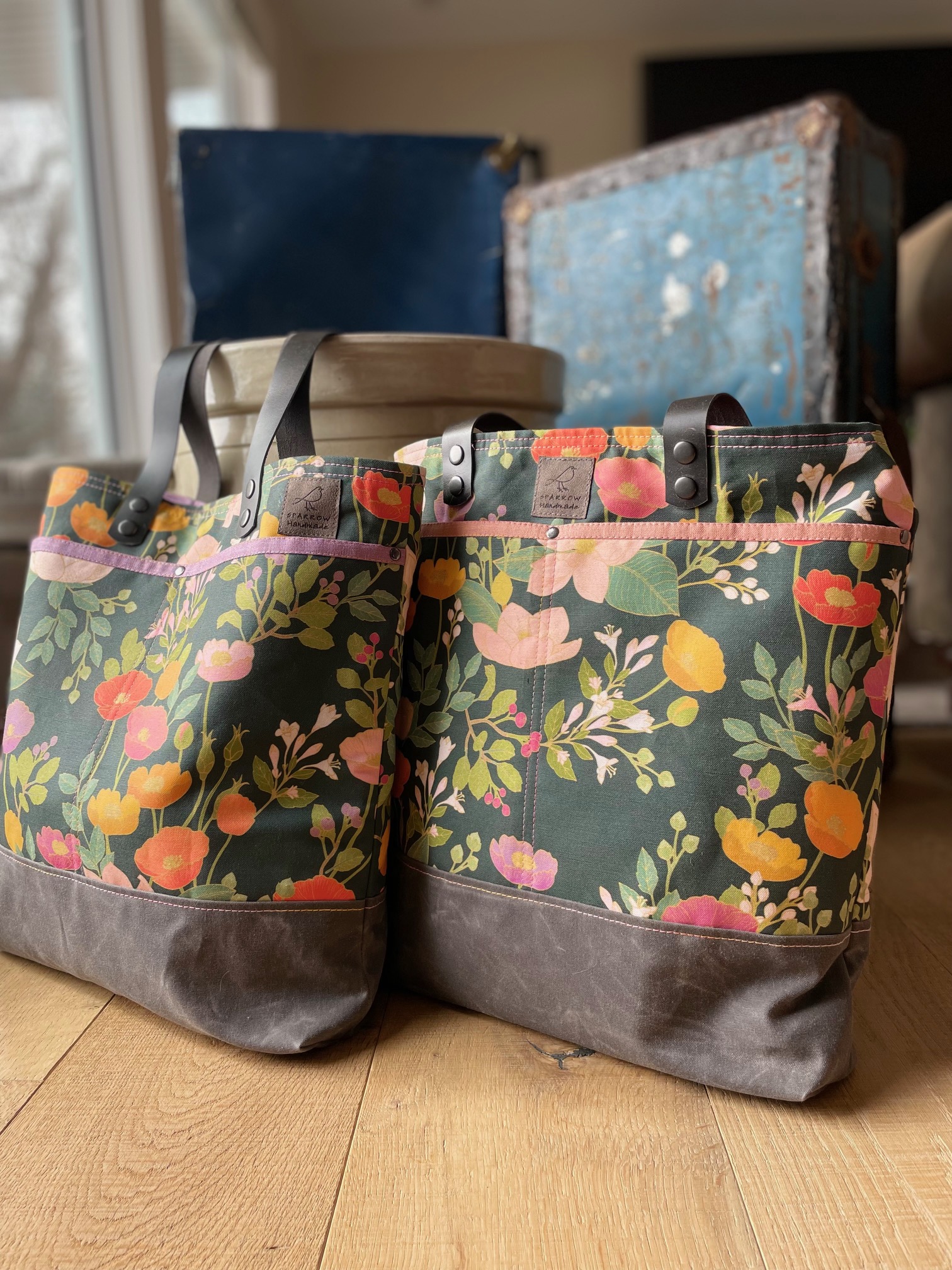 Tote bags in a floral canvas with brown waxed canvas base.